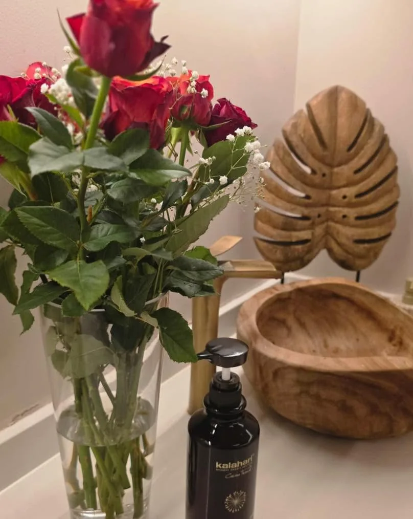 Fresh roses and warm wooden decor on a counter at Skulpt