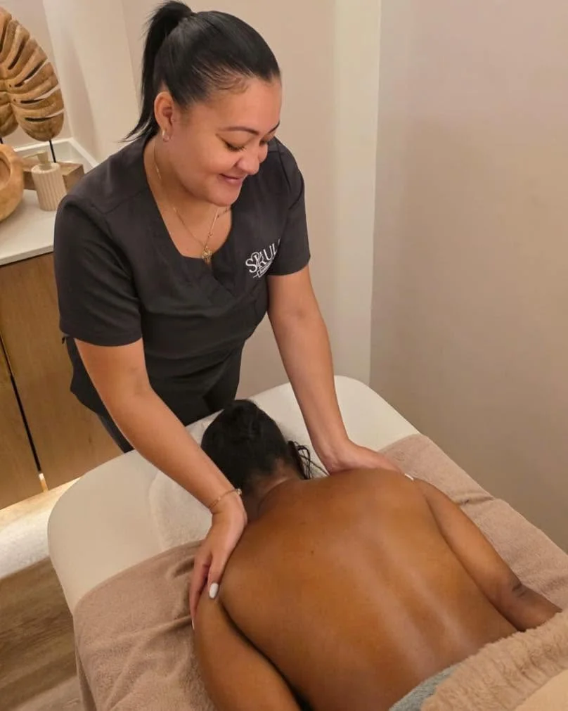 Therapist performing a back massage in a treatment room at Skulpt